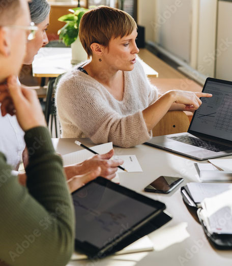 Photo of a team leader coaching a group of employees.